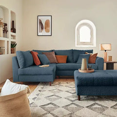Sleeper sofa with a movable footstool, with soft cushioning and a space-saving layout