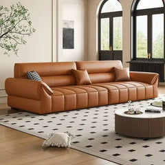 wide leatherette sofa with deep square cushioning and a low relaxed shape — room setting showing the relaxed seating arran...