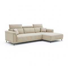 beige l shape sofa with adjustable head support, rounded arms and slim raised legs — room setting showing the relaxed seat...