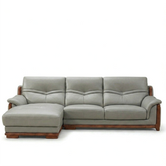 corner sofa with deep cushions, rounded arms and warm polished wooden side details — room setting showing the relaxed seat...