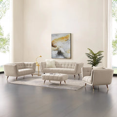 beige fabric sofa with soft curved arms, square cushion details and raised wooden legs — close view showing the colour and...
