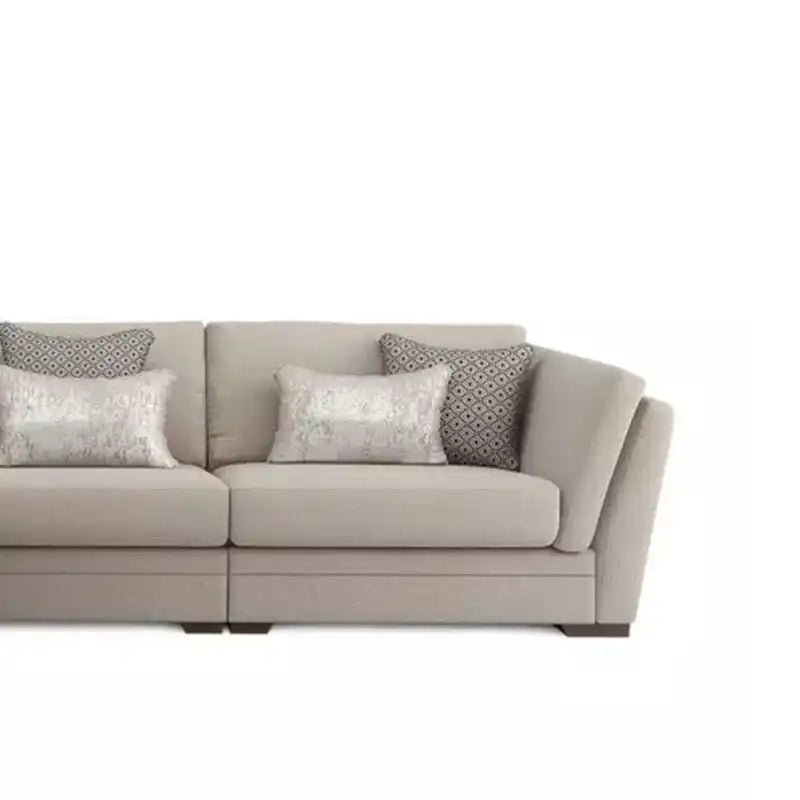 beige corner sofa with a compact l shape, soft cushions and a smooth fabric finish — front view in a bright living room