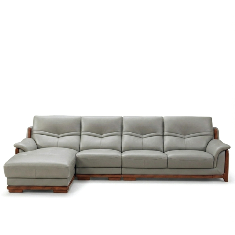 corner sofa with deep cushions, rounded arms and warm polished wooden side details — angled view showing the full shape an...