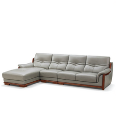 corner sofa with deep cushions, rounded arms and warm polished wooden side details — side angle showing the arms and raise...