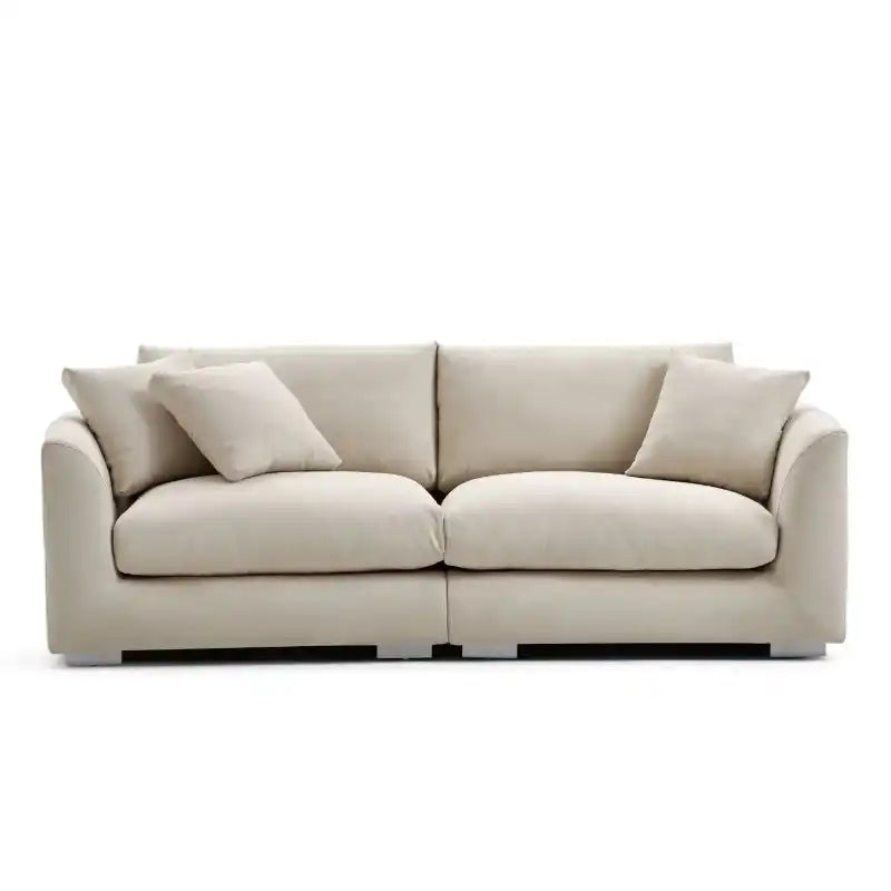 wide l shape fabric sofa with rounded arms, loose back cushions and deep comfortable seating — close view showing the cush...
