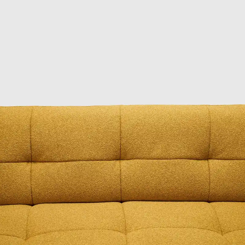 warm mustard rounded sofa with deep square cushioning and a soft textured finish — wide room view showing the complete sea...