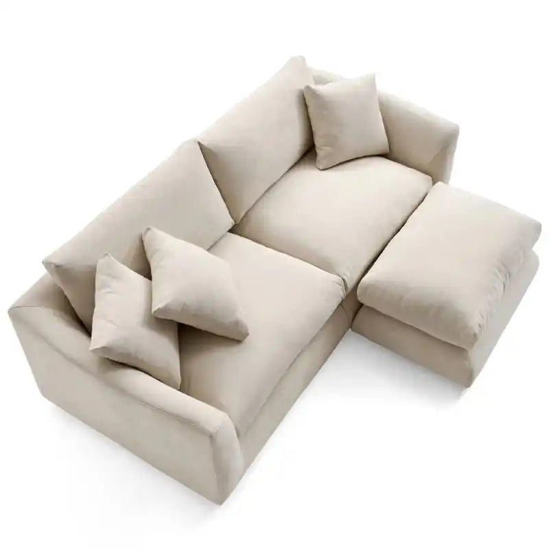 wide l shape fabric sofa with rounded arms, loose back cushions and deep comfortable seating — front angle showing the bac...