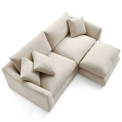 wide l shape fabric sofa with rounded arms, loose back cushions and deep comfortable seating — front angle showing the bac...