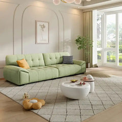 modern fabric sofa with clean square cushion details, soft arms and a simple balanced shape — front view in a bright livin...