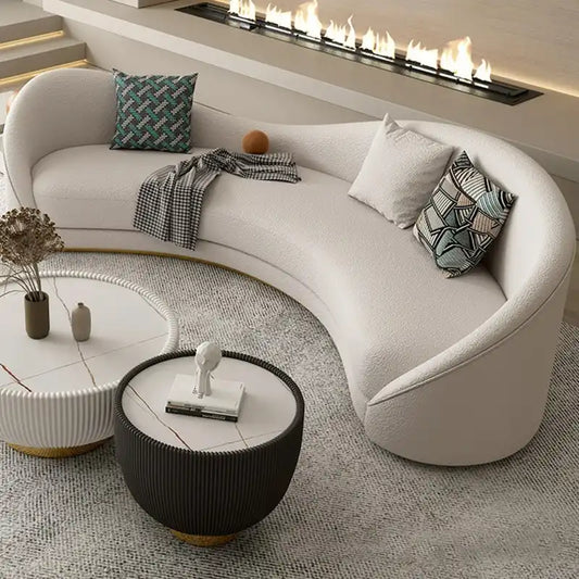 off white curved sofa with deep cushions, smooth rounded arms and soft textured fabric — front view in a bright living room