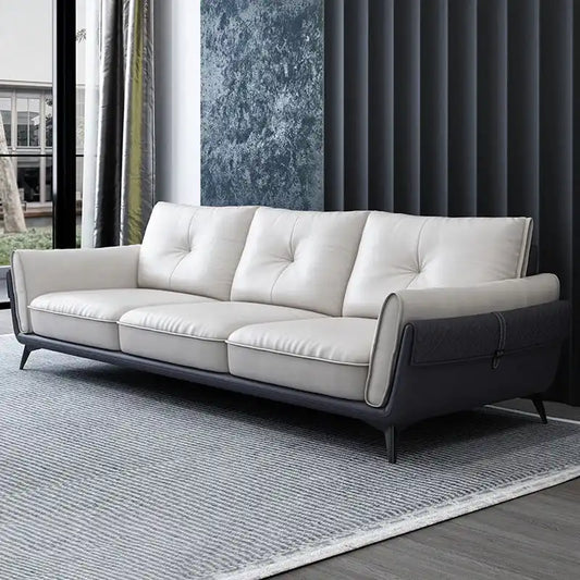 dual tone beige and charcoal fabric sofa with a soft cushioned back and deep seating — front view in a bright living room