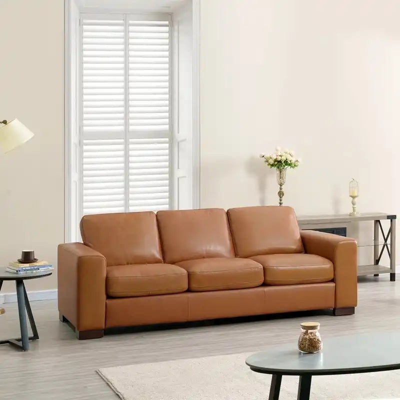 easy clean faux leather sofa with wide straight arms and thick supportive cushions — front view in a bright living room