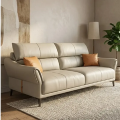 beige leatherette sofa with supportive high back cushions, rounded arms and slim raised legs — front view in a bright livi...