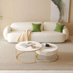 soft curved fabric sofa with cloud like cushions, wraparound arms and a low grounded base — angled view showing the full s...