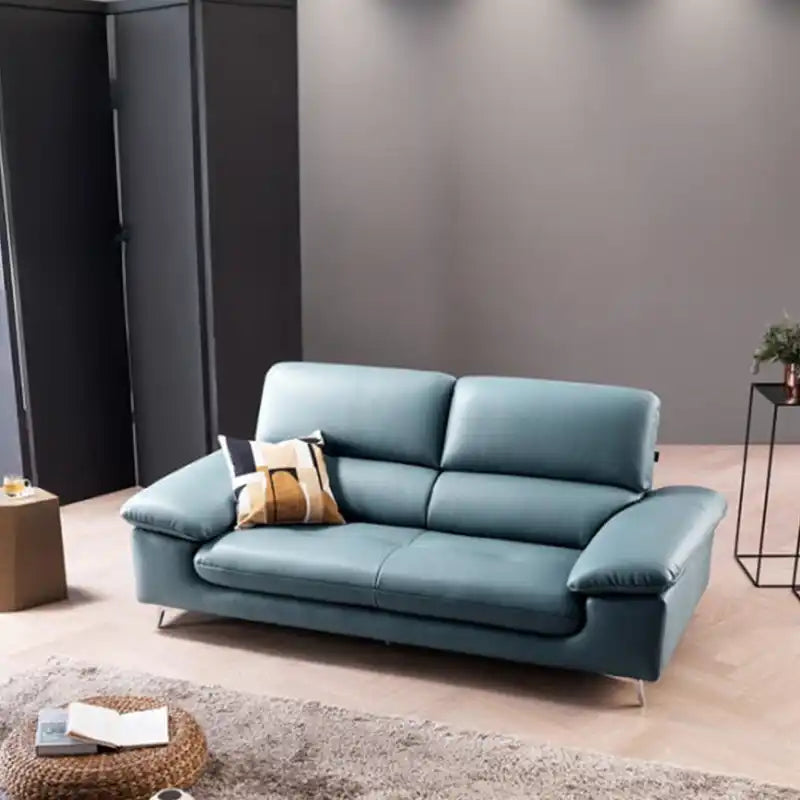 modern sofa with soft curved arms, supportive back cushions and raised chrome finish legs — angled view showing the full s...