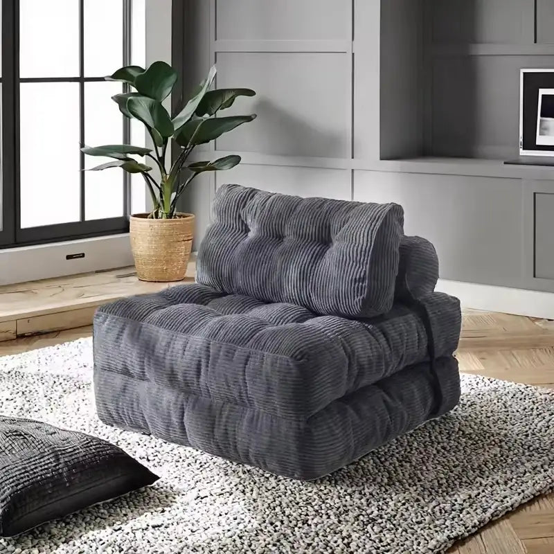 Folding sofa bed in soft ribbed fabric, with a pull-out sleeping area for overnight guests