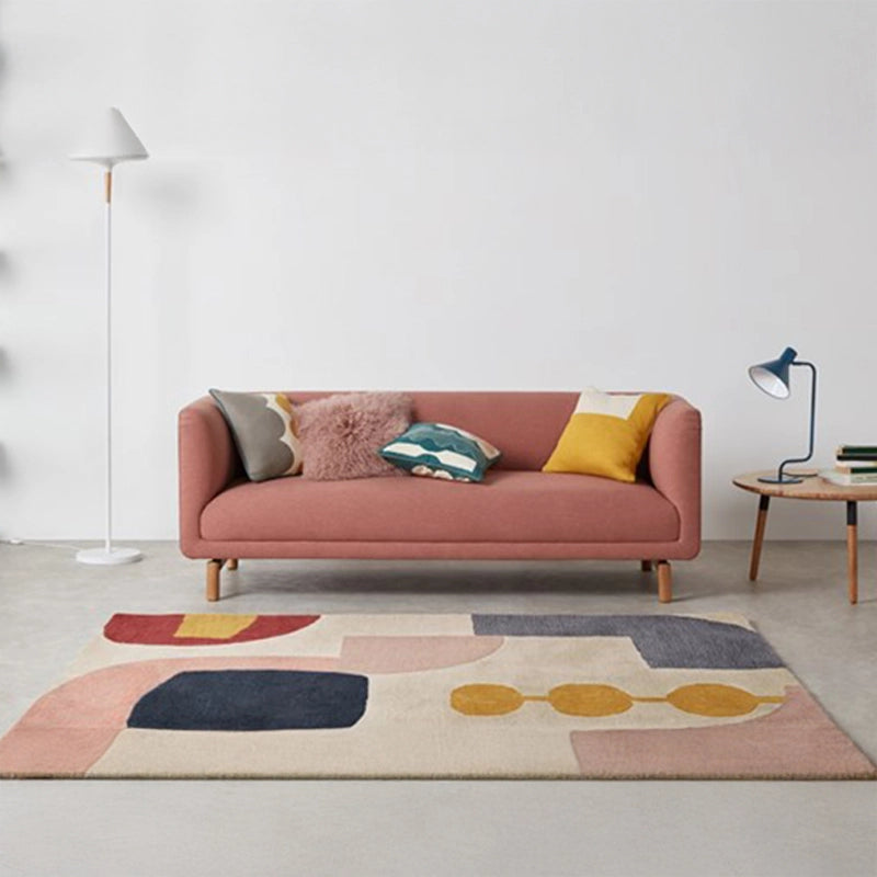 curved fabric sofa with soft wraparound arms, deep cushioning and raised wooden legs — angled view showing the full shape...