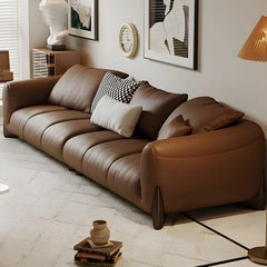 warm brown sofa with deep cushions, soft back support and wide comfortable arms — angled view showing the full shape and c...