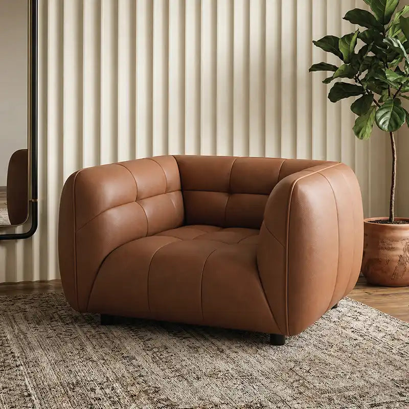 warm brown luxury sofa with deep square cushioning, rounded edges and a low relaxed shape — side angle showing the arms an...