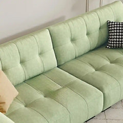 modern fabric sofa with clean square cushion details, soft arms and a simple balanced shape — close view showing the cushi...