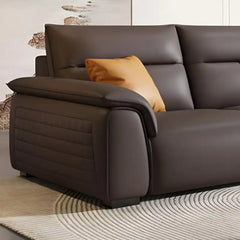 dark brown luxury sofa with broad pillow soft arms, cushioned back and detailed side panels — side angle showing the arms...