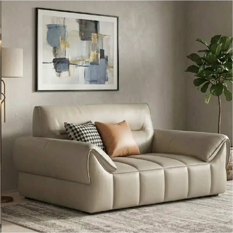 wide leatherette sofa with deep square cushioning and a low relaxed shape — side angle showing the arms and raised base