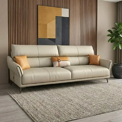 beige leatherette sofa with supportive high back cushions, rounded arms and slim raised legs — side angle showing the arms...