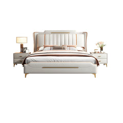 smooth ivory upholstery, metallic detailing, and tapered gold-finish legs reflect a modern bed design suited