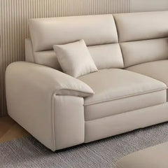 beige l shape leatherette sofa with deep seating, high back cushions and wide padded arms — close view showing the cushion...