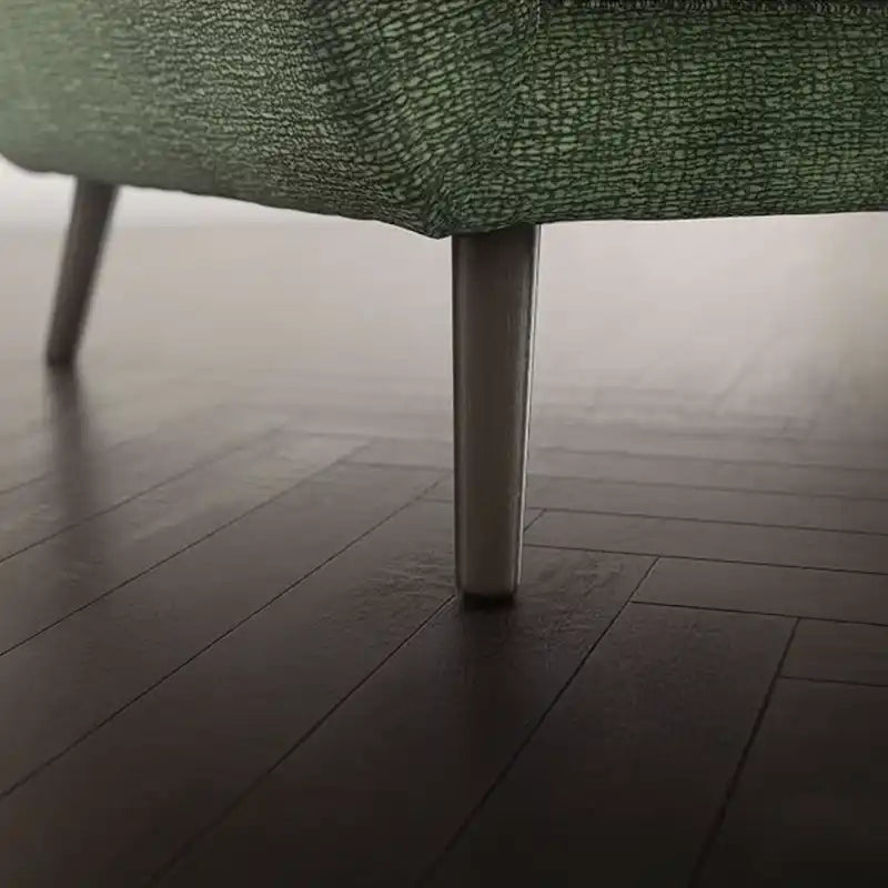 modern fabric sofa with rounded arms, soft cushions and slim raised legs — close view showing the cushion and surface details