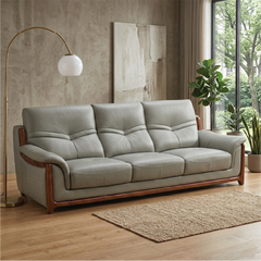corner sofa with deep cushions, rounded arms and warm polished wooden side details — close view showing the cushion and su...