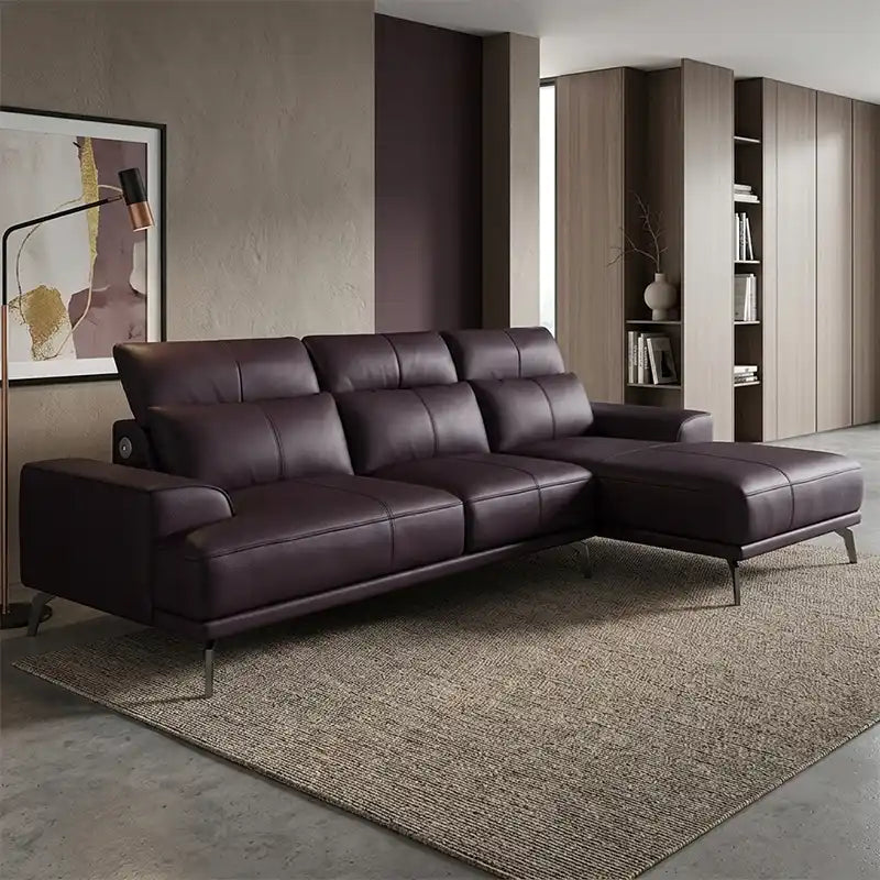 modern l shape sofa with high back cushions, slim metal legs and deep comfortable seating — wide room view showing the com...