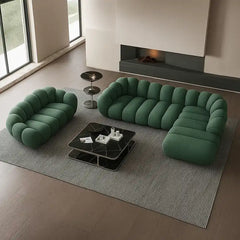 soft curved sofa with rounded cushion sections, a cloud like shape and a low relaxed base — wide room view showing the com...