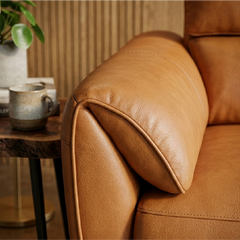 tan l shape sofa with deep cushions, supportive back panels and wide padded arms — front angle showing the back support an...
