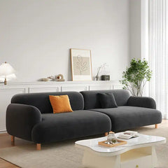 rounded fabric sofa with deep cushions, soft wide arms and a clean modern finish — front angle showing the back support an...