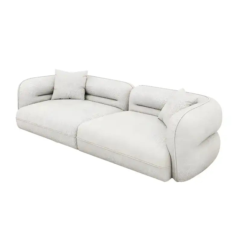 low lounge sofa with thick cushions, loose back pillows and soft rounded edges — front angle showing the back support and...