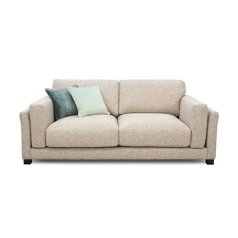 modern neutral fabric sofa with wide padded arms, thick cushions and clean straight lines — front angle showing the back s...