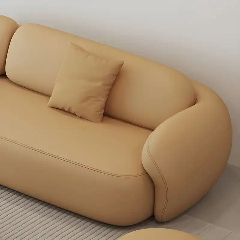 soft curved fabric sofa with cloud like cushions, wraparound arms and a low grounded base — front angle showing the back s...