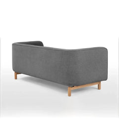 curved fabric sofa with soft wraparound arms, deep cushioning and raised wooden legs — front angle showing the back suppor...