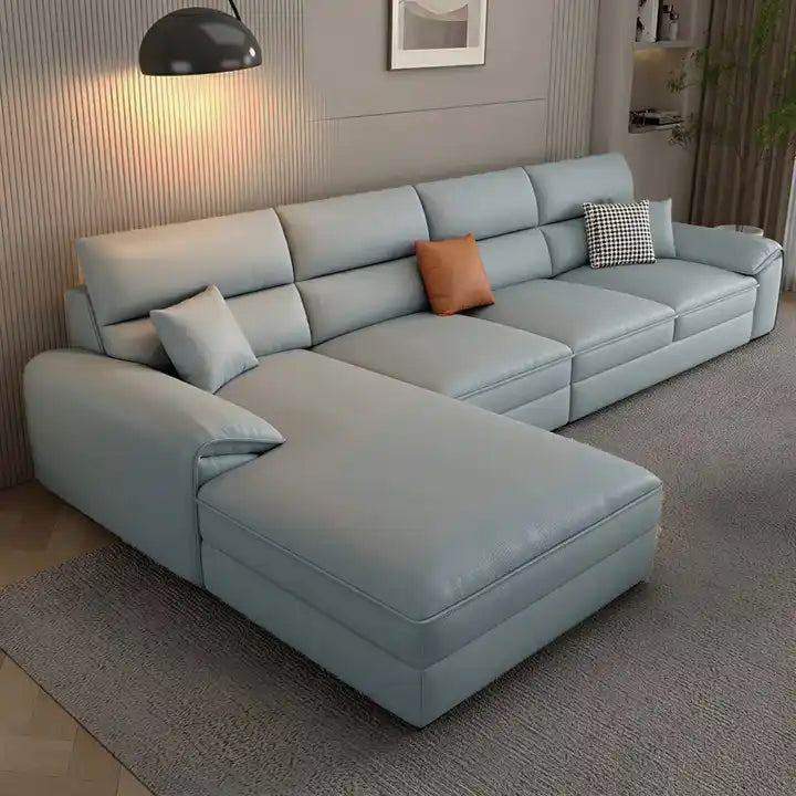 beige l shape leatherette sofa with deep seating, high back cushions and wide padded arms — alternate angle showing the fu...
