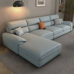 beige l shape leatherette sofa with deep seating, high back cushions and wide padded arms — alternate angle showing the fu...