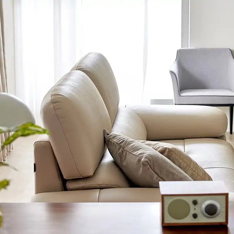 modern sofa with soft curved arms, supportive back cushions and raised chrome finish legs — full view with the complete sh...
