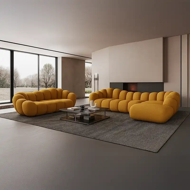soft curved sofa with rounded cushion sections, a cloud like shape and a low relaxed base — close view showing the colour...