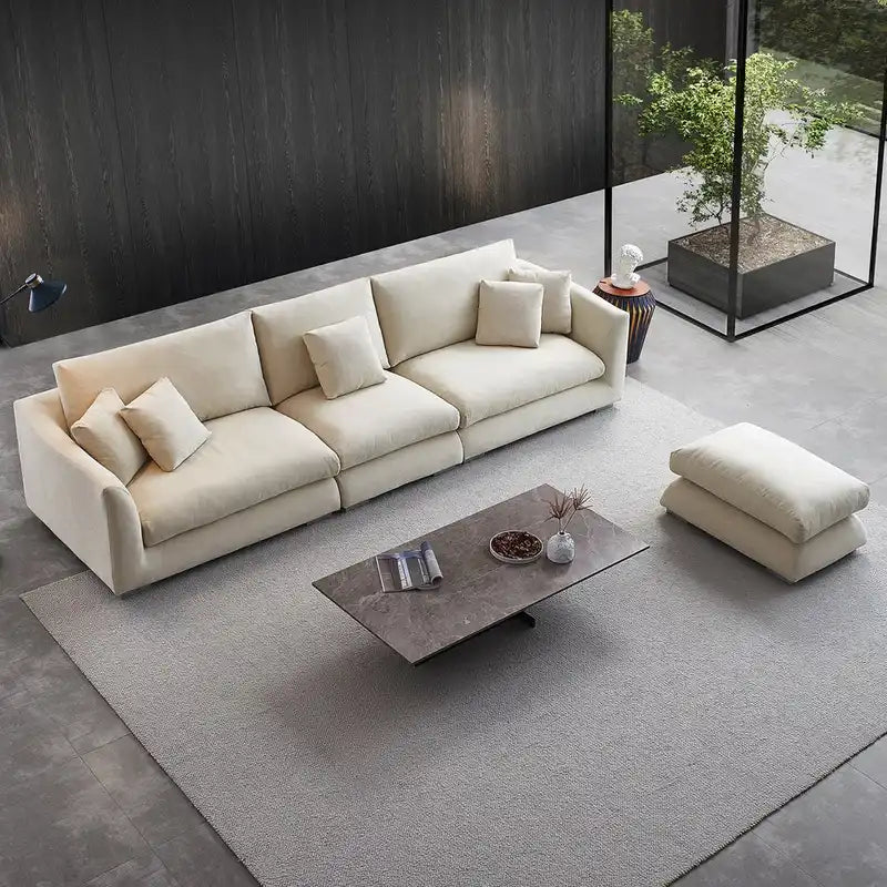 wide l shape fabric sofa with rounded arms, loose back cushions and deep comfortable seating — full view with the complete...