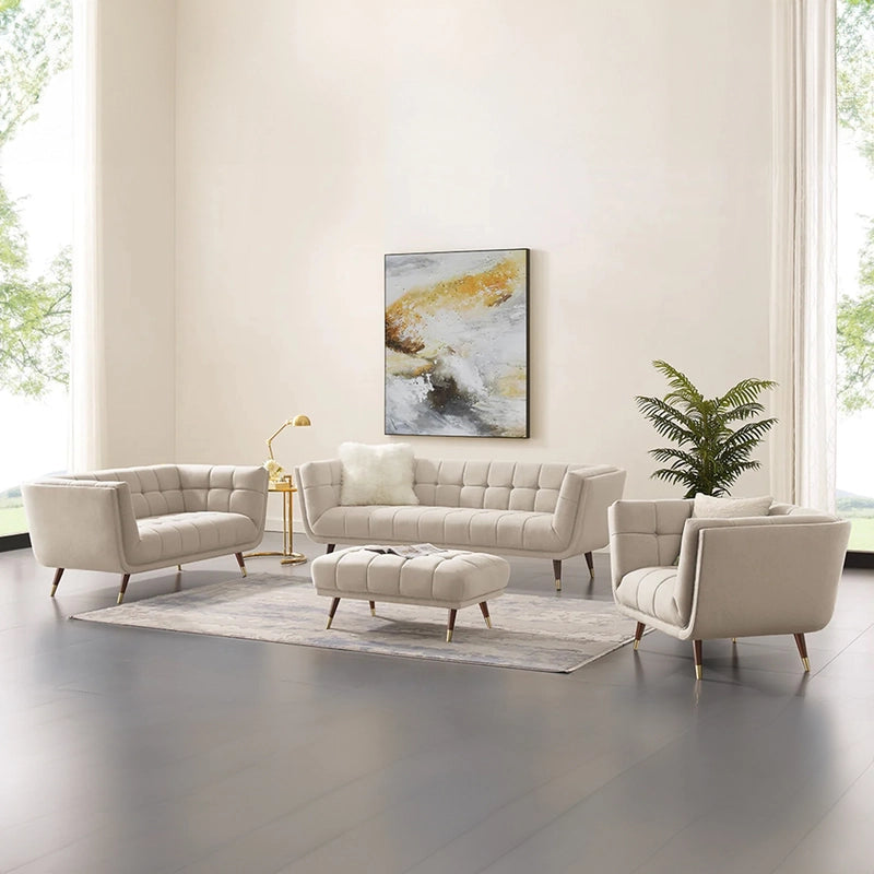 beige fabric sofa with soft curved arms, square cushion details and raised wooden legs — close view showing the colour and...
