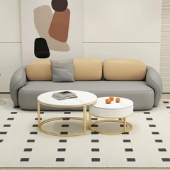 soft curved fabric sofa with cloud like cushions, wraparound arms and a low grounded base — front view in a bright living...