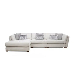 beige corner sofa with a compact l shape, soft cushions and a smooth fabric finish — angled view showing the full shape an...