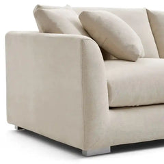 wide l shape fabric sofa with rounded arms, loose back cushions and deep comfortable seating — angled view showing the ful...