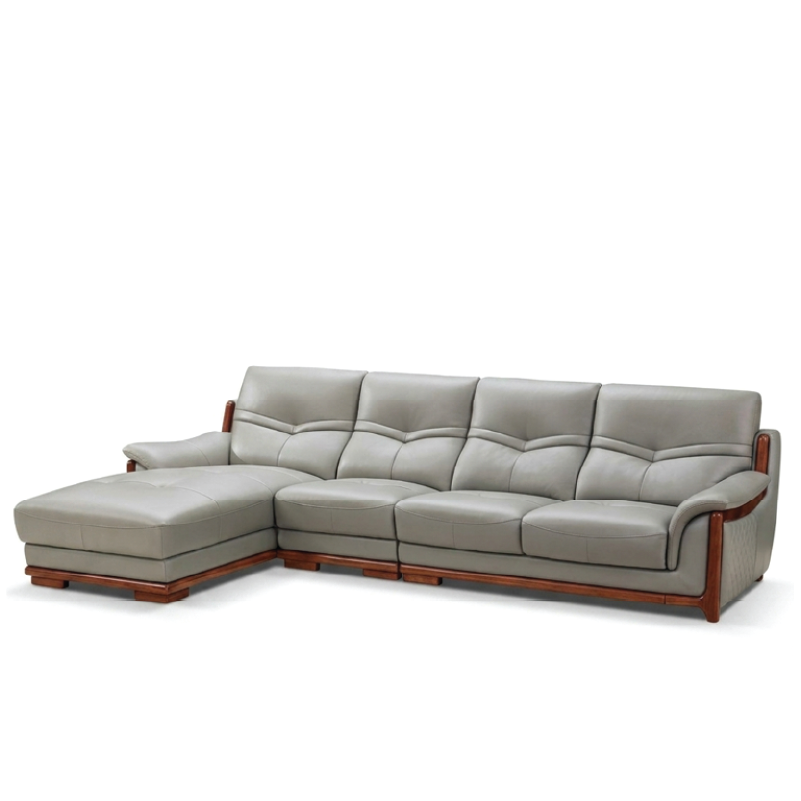 corner sofa with deep cushions, rounded arms and warm polished wooden side details — side angle showing the arms and raise...