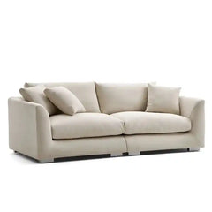wide l shape fabric sofa with rounded arms, loose back cushions and deep comfortable seating — side angle showing the arms...